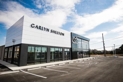 Exterior of the Carylton Shelton Mazda dealership building with black and white facade and clear storefront windows.